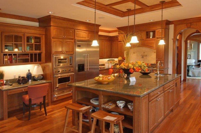 Large kitchen with a wood island and built-in ovens