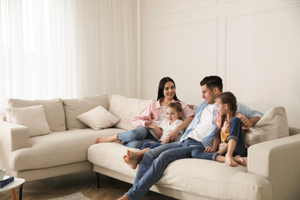 Family relaxing together on a couch at home